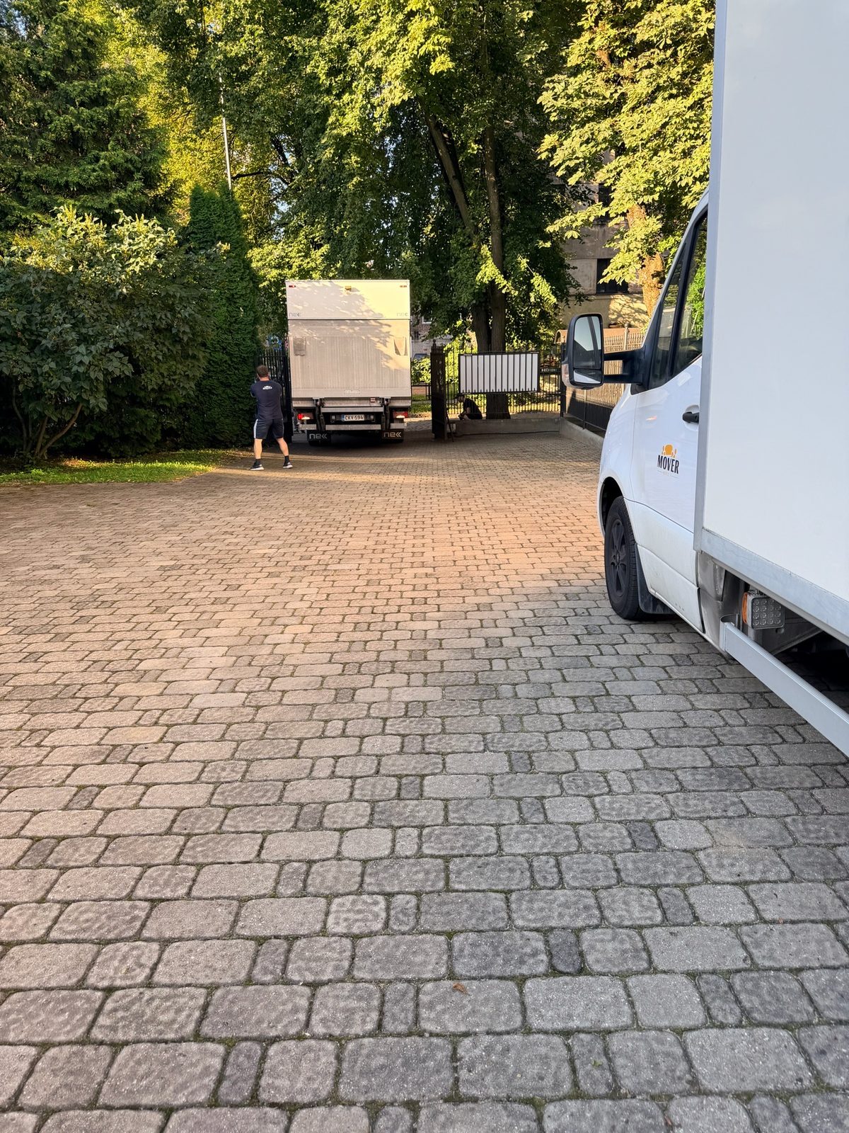 Two Mover trucks in a courtyard
